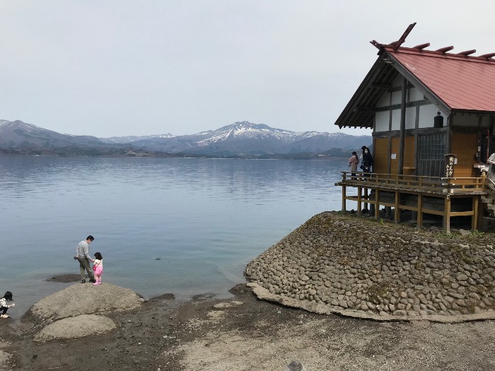 At Lake Tazawa, a small temple and Mount Akita in the distance