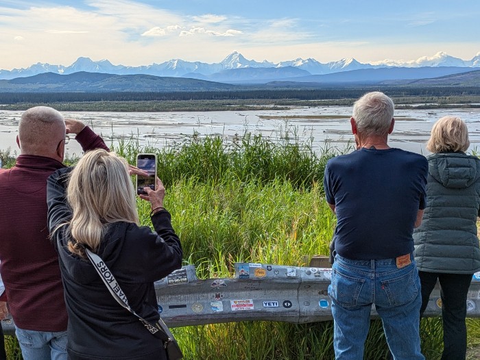 Snowcapped mountains beyond the lake are begging for their pictures to be taken!